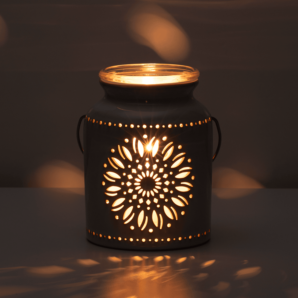 Heirloom Flower Scentsy Warmer glowing warmly in a dark room