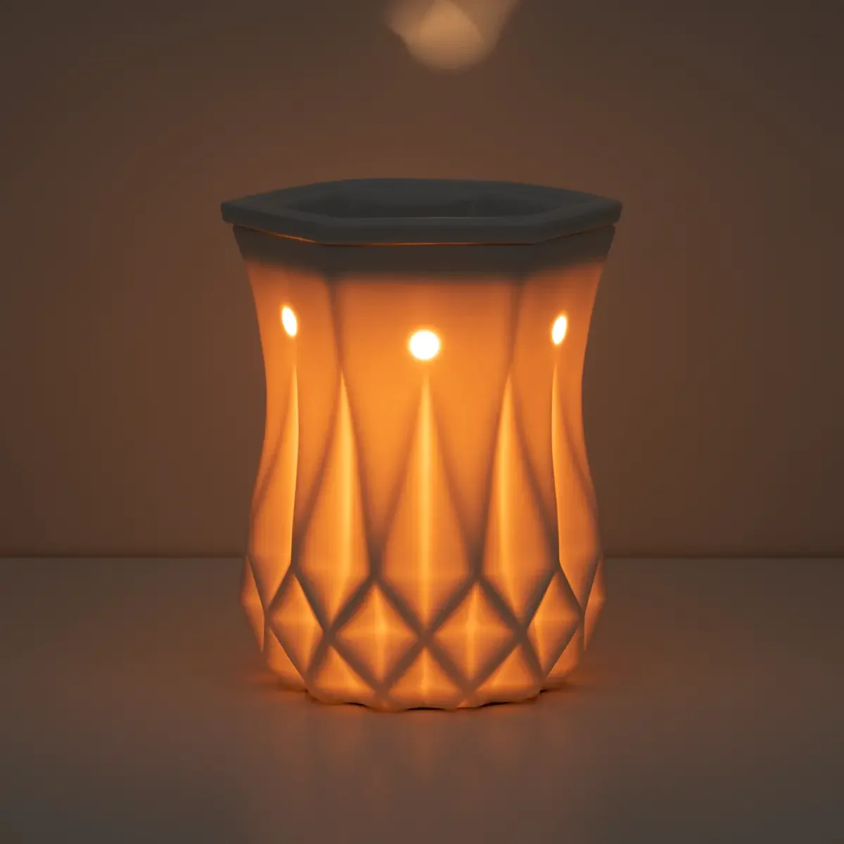 Alabaster Scentsy Warmer in a dark room glowing to show the beauty