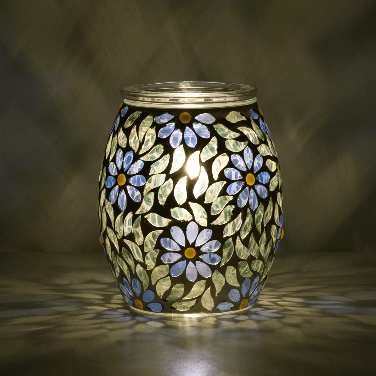 Periwinkle Petals Scentsy Warmer glowing and reflecting colour in a dark room