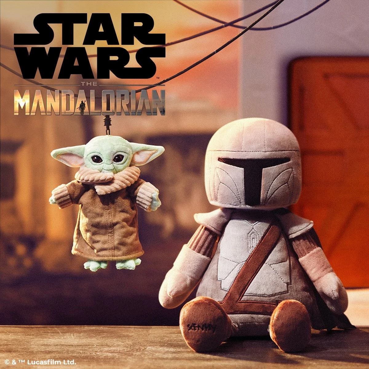The Mandalorian Scentsy Buddy and Grogu plush sitting side by side in a warm styled room with Star Wars branding