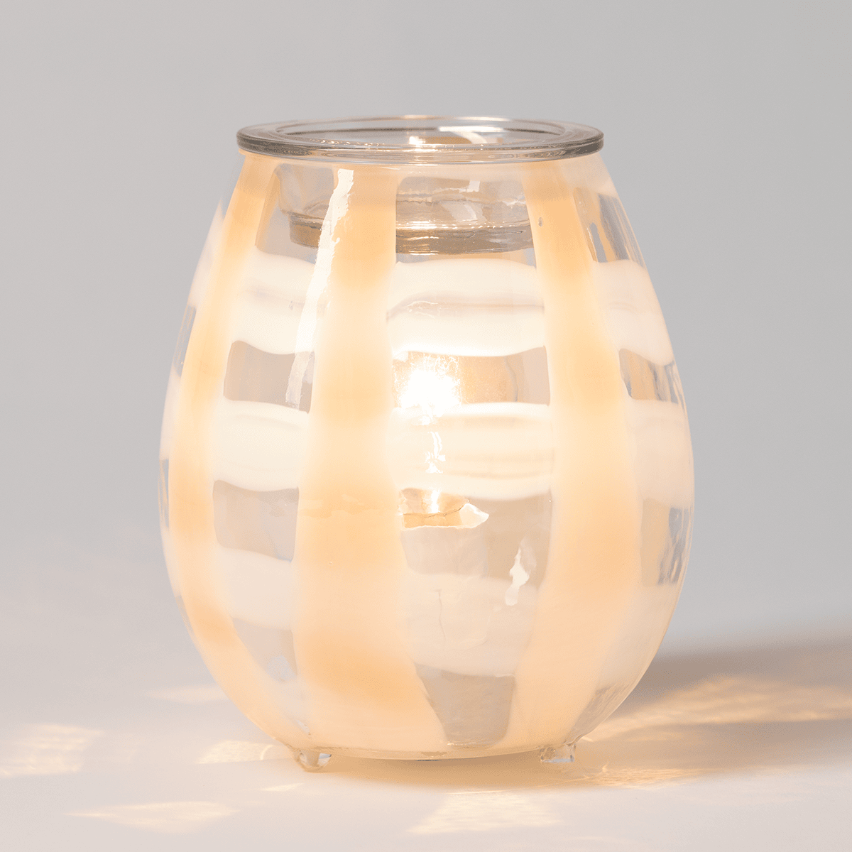 Lightweave Scentsy warmer illuminated on a neutral background glowing