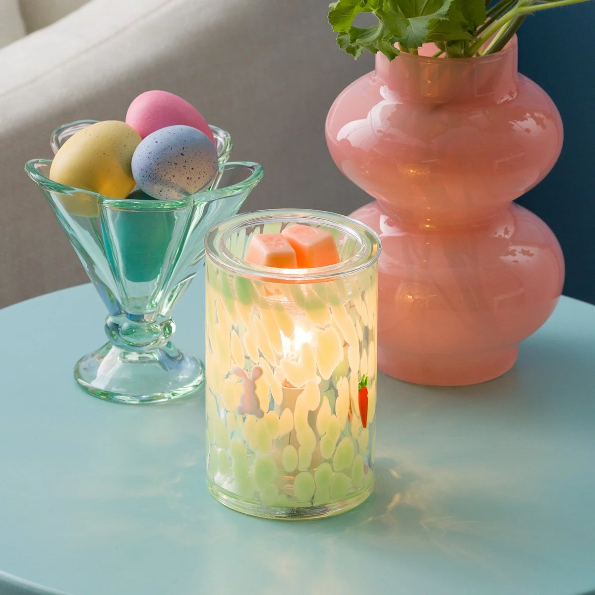 The Verdant Escape Scentsy Warmer is styled with pastel Easter accents and decorative eggs, highlighting its fresh seasonal design