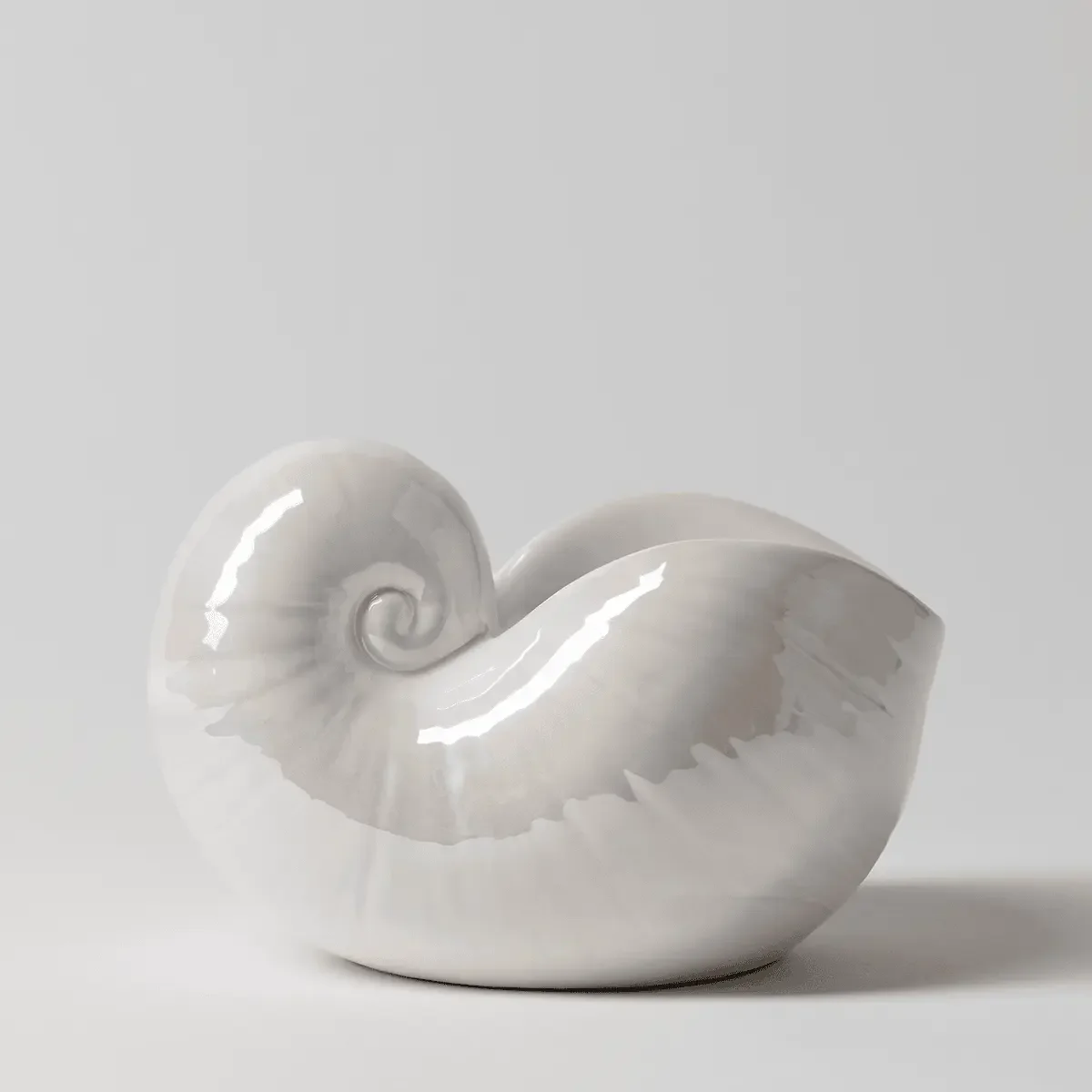 Side view of Scentsy Nautilus warmer showing glossy spiral shell detail and curved design