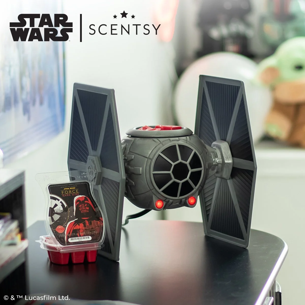 TIE Fighter Scentsy Warmer displayed on a tabletop with Dark Side of the Force wax bar beside it in a bright modern setting