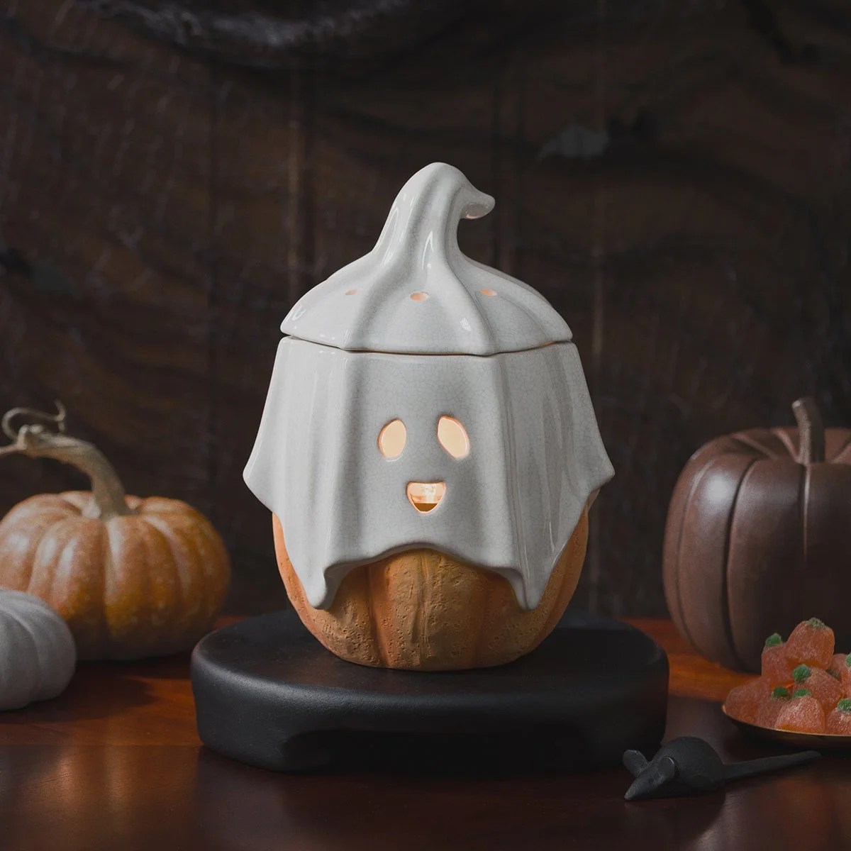 Ghostlight Gourd Scentsy Warmer glowing among pumpkins and spooky Halloween décor