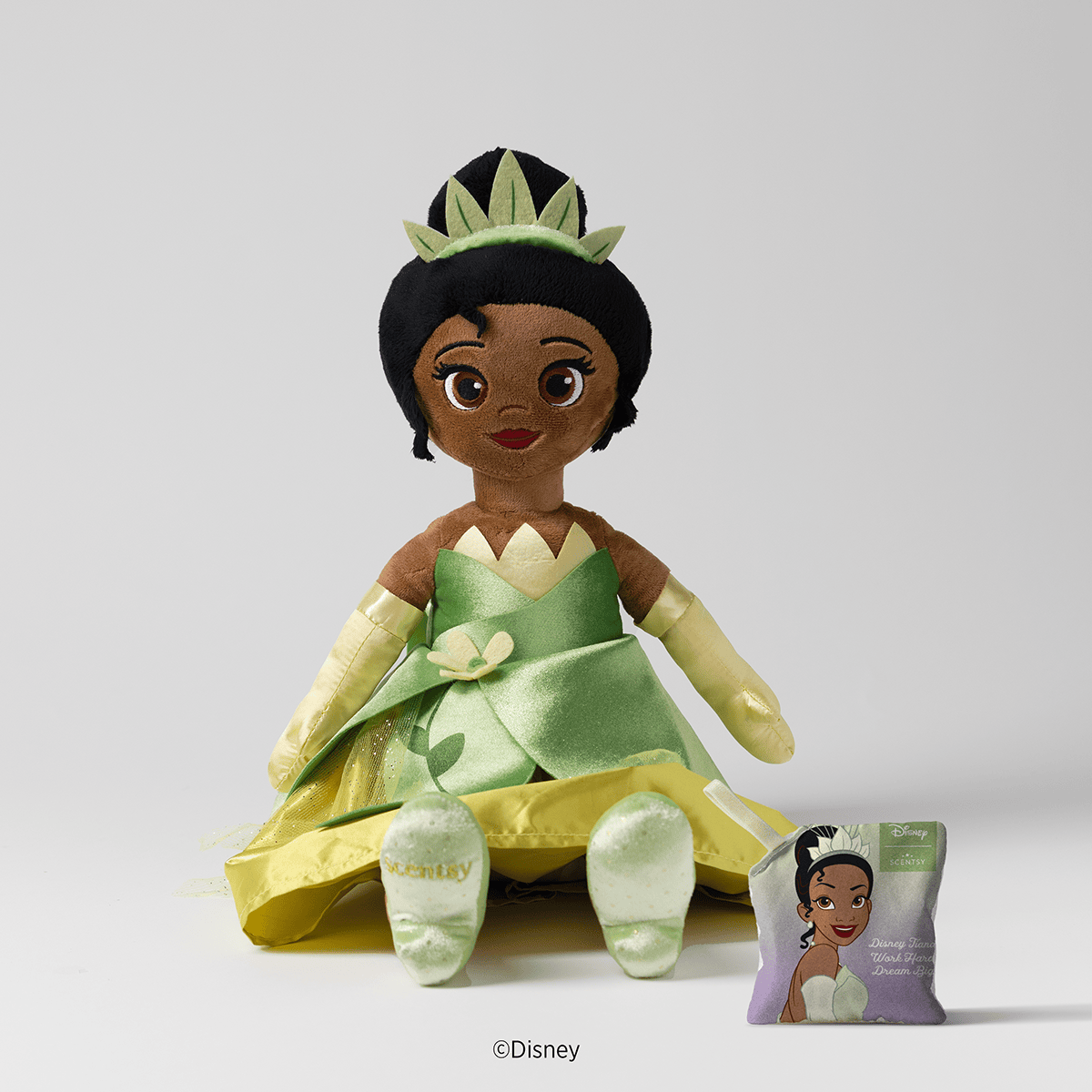 Official front packshot of the Princess Tiana Scentsy Buddy featuring her petal-inspired gown and coordinating fragrance Scent Pak