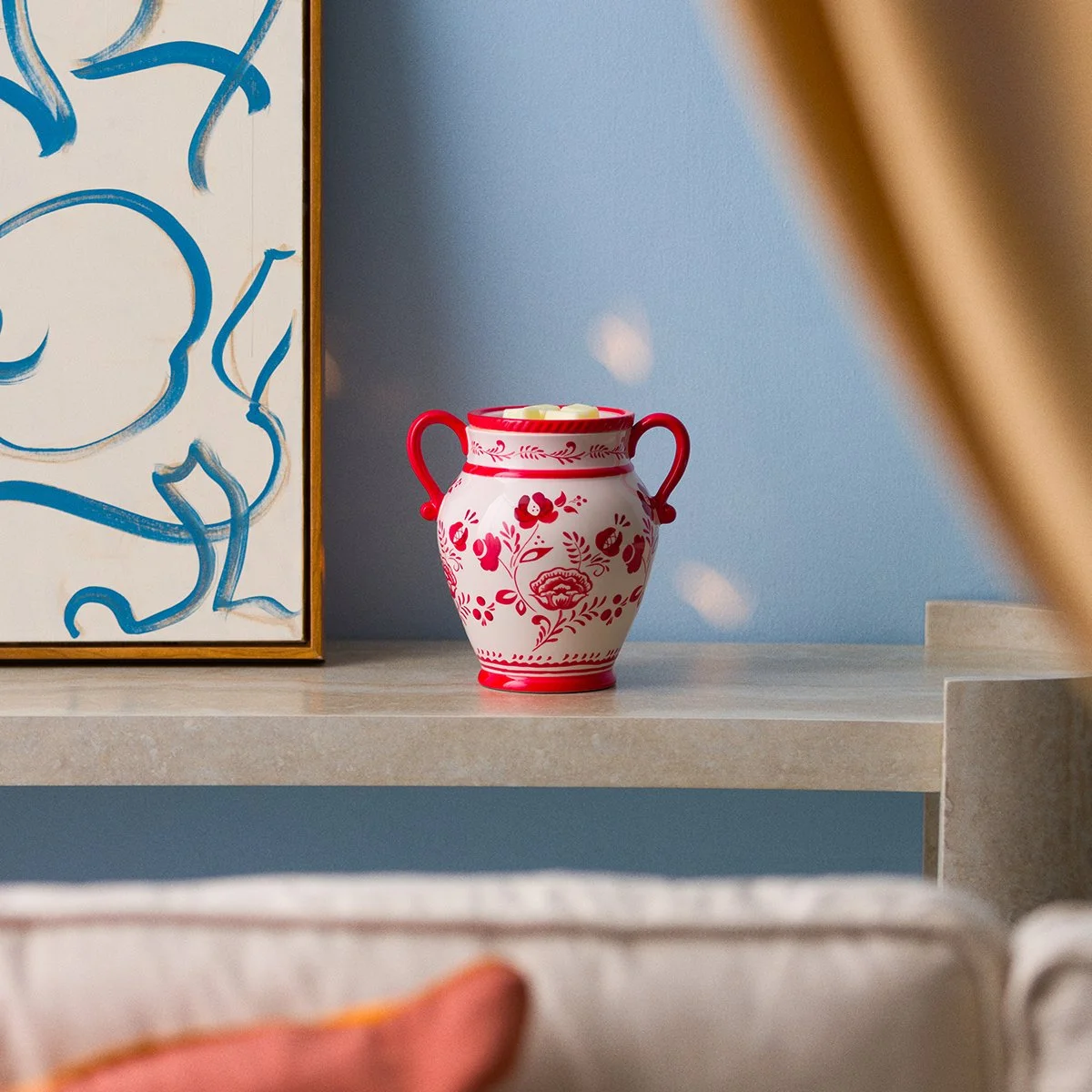 La Vita Rosa Scentsy Warmer displayed on a modern shelf, featuring a vintage Italian-inspired ceramic vase design with red floral details from the July 2026 Monthly Edit.