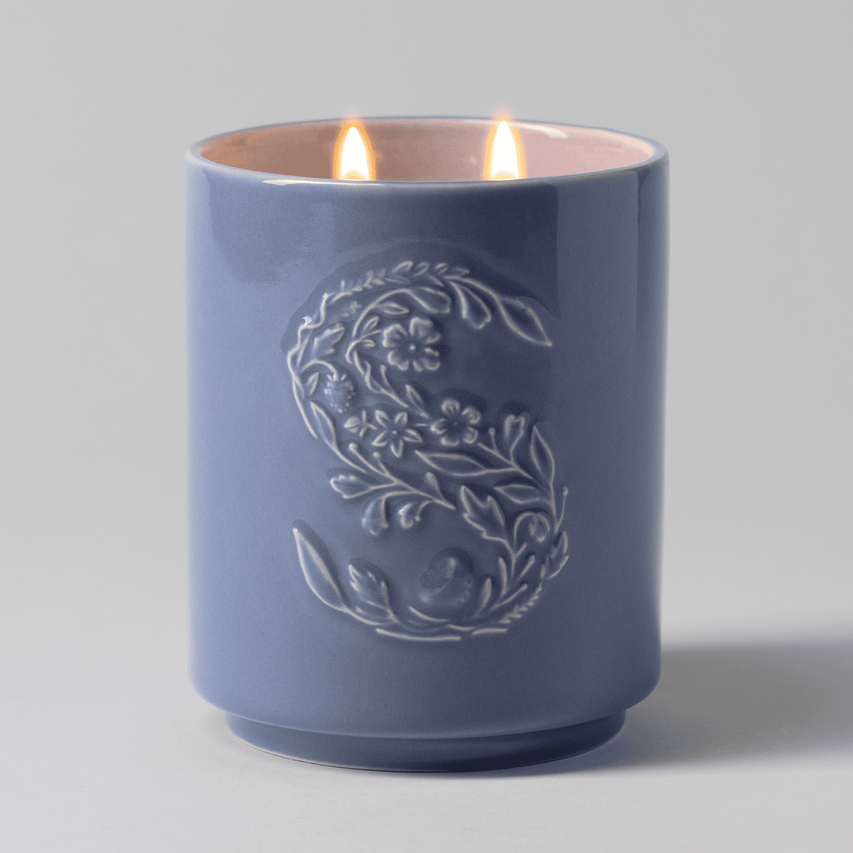 Pure Cashmere Scentsy Candle lit with a flame