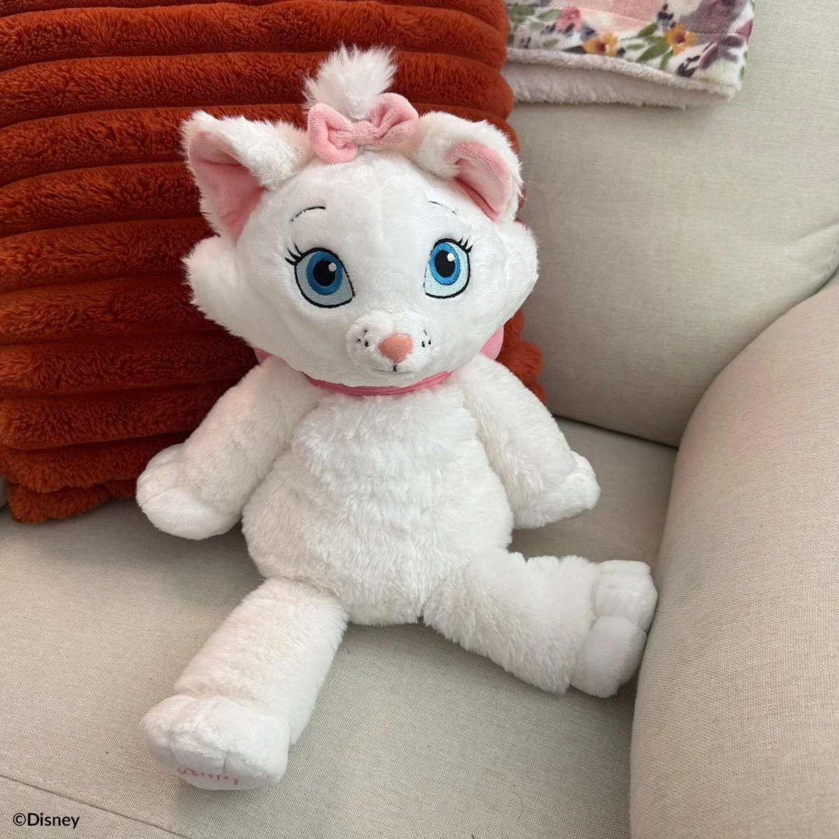 Disney Marie Scentsy Buddy plush inspired by The Aristocats styled on a couch
