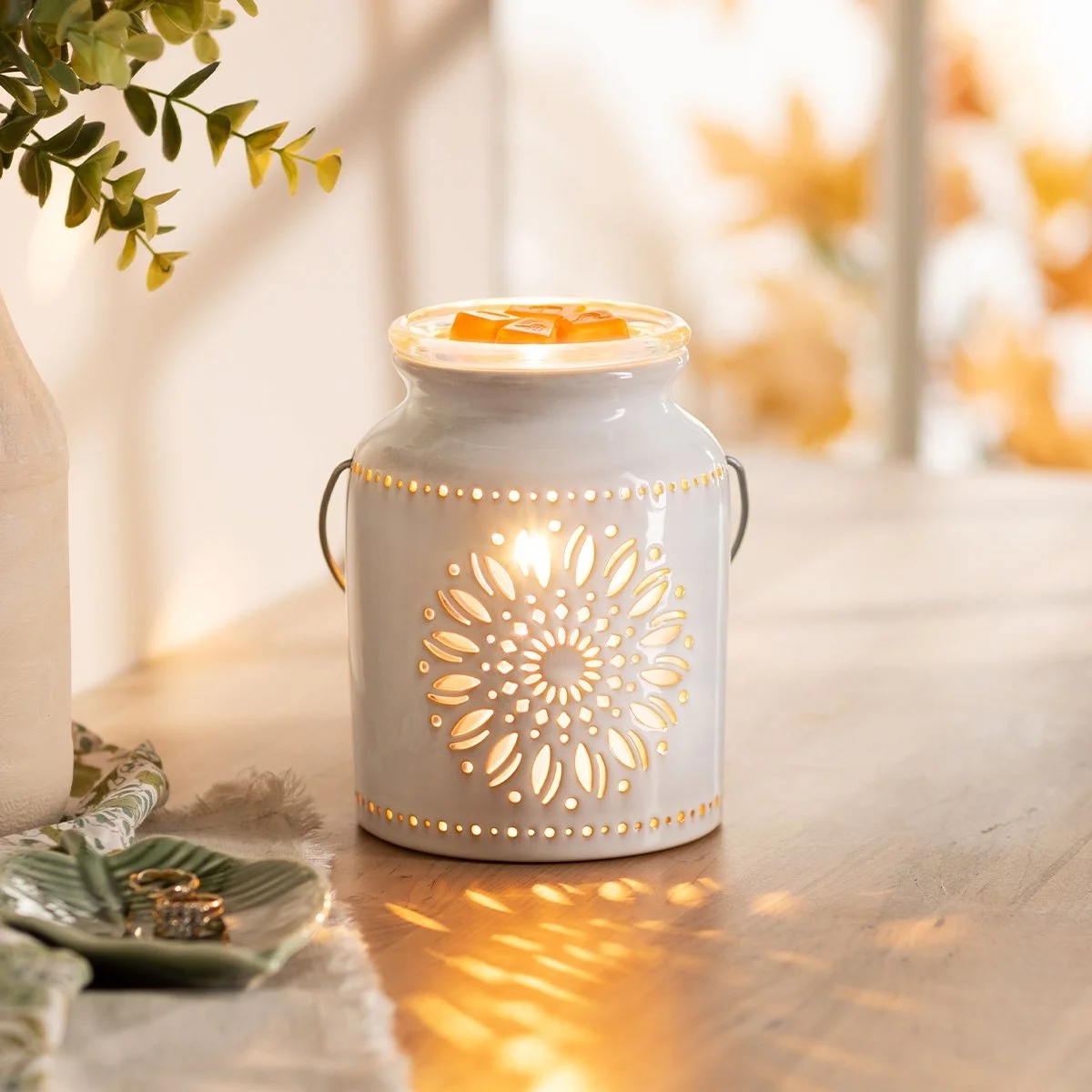 Heirloom Flower Scentsy Warmer styled in a bright room glowing with wax in the dish