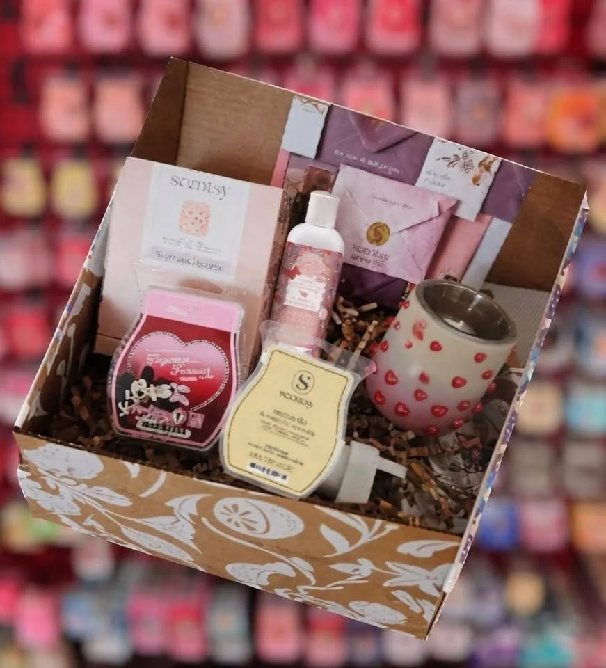 Open February 2026 Scentsy Whiff Box showing Soaring Hearts mini warmer, Scentsy wax bars, body wash, and curated monthly contents