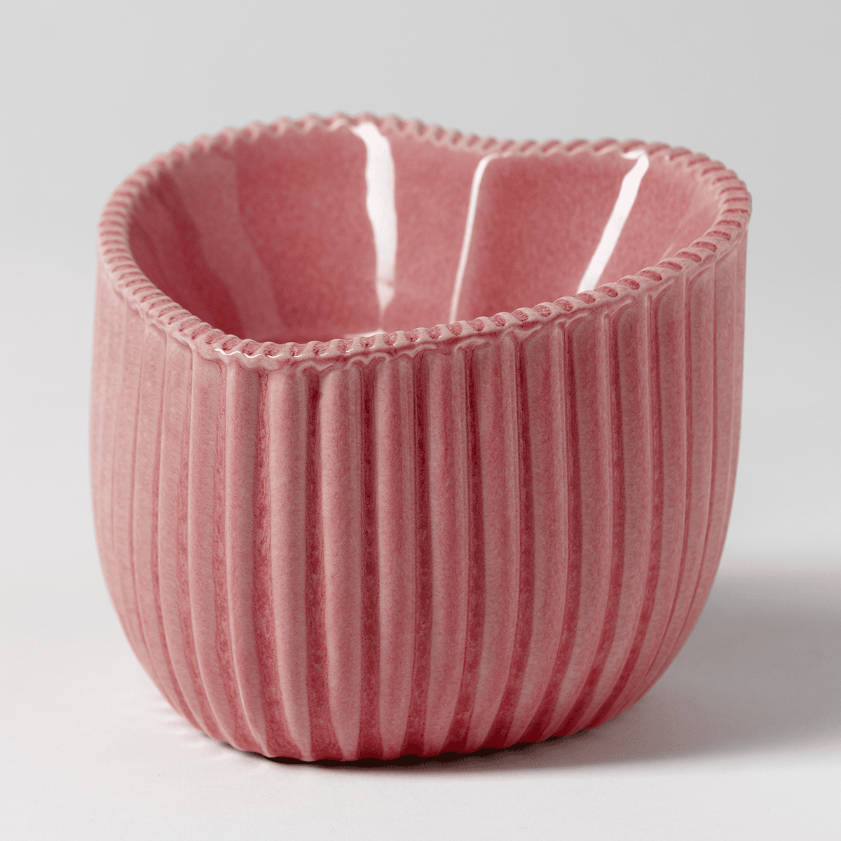 Scentsy Heart of Hope Charitable Cause Warmer with pink ceramic finish displayed against a neutral grey background side view