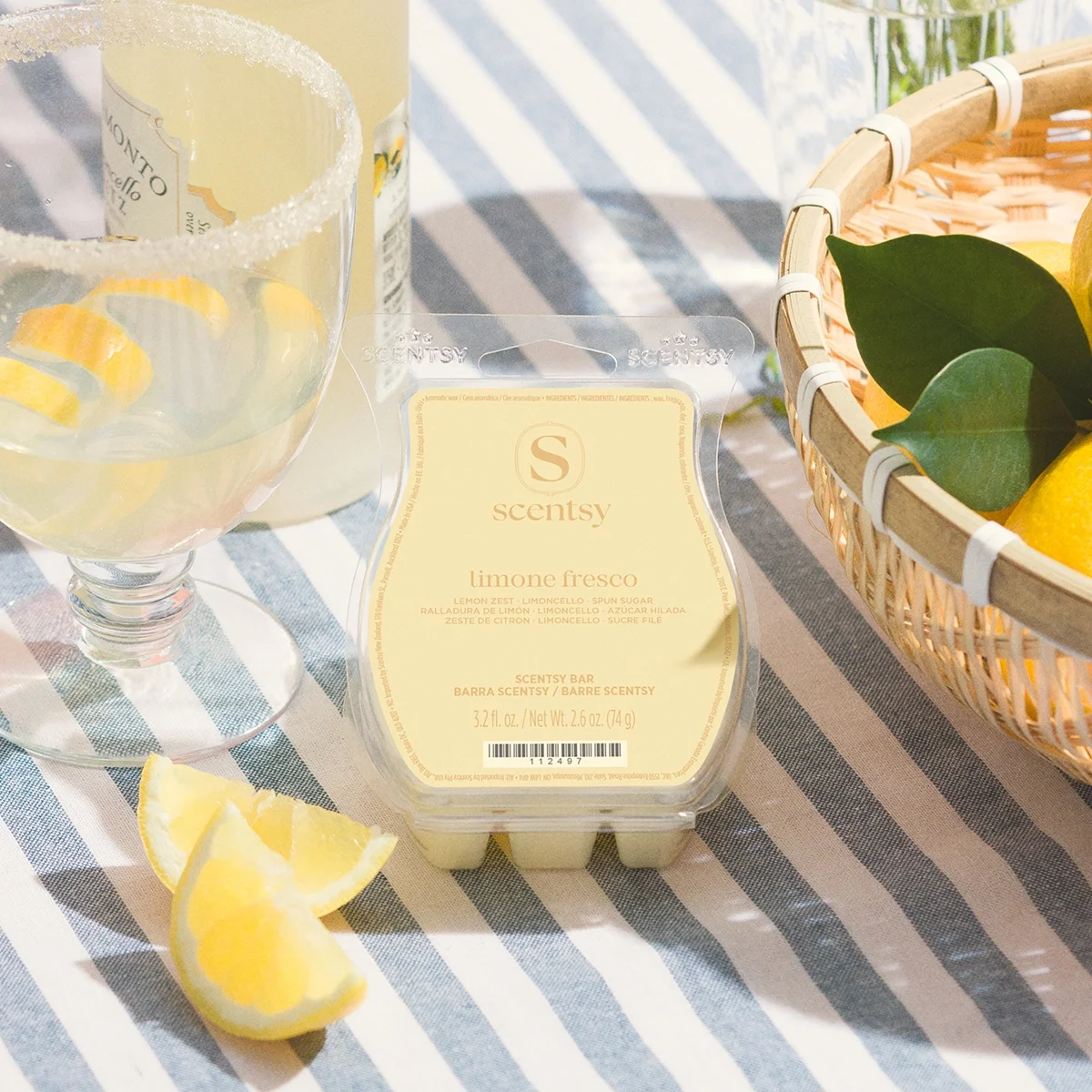 Limone Fresco Scentsy Wax Bar displayed beside fresh lemons and a chilled glass of limoncello, inspired by the sun-soaked lemon groves of southern Italy