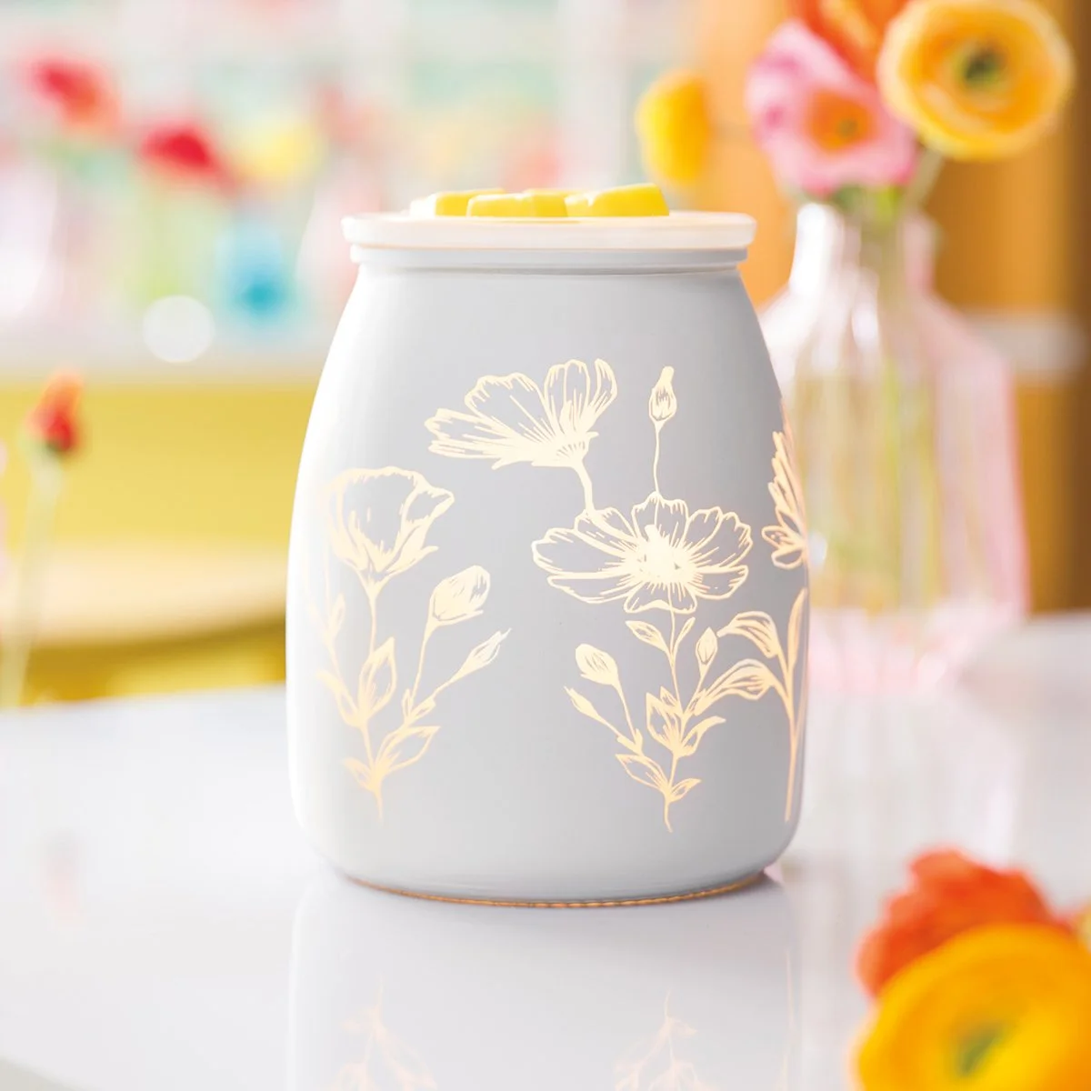 Flower Garden Scentsy Warmer styled in a room glowing