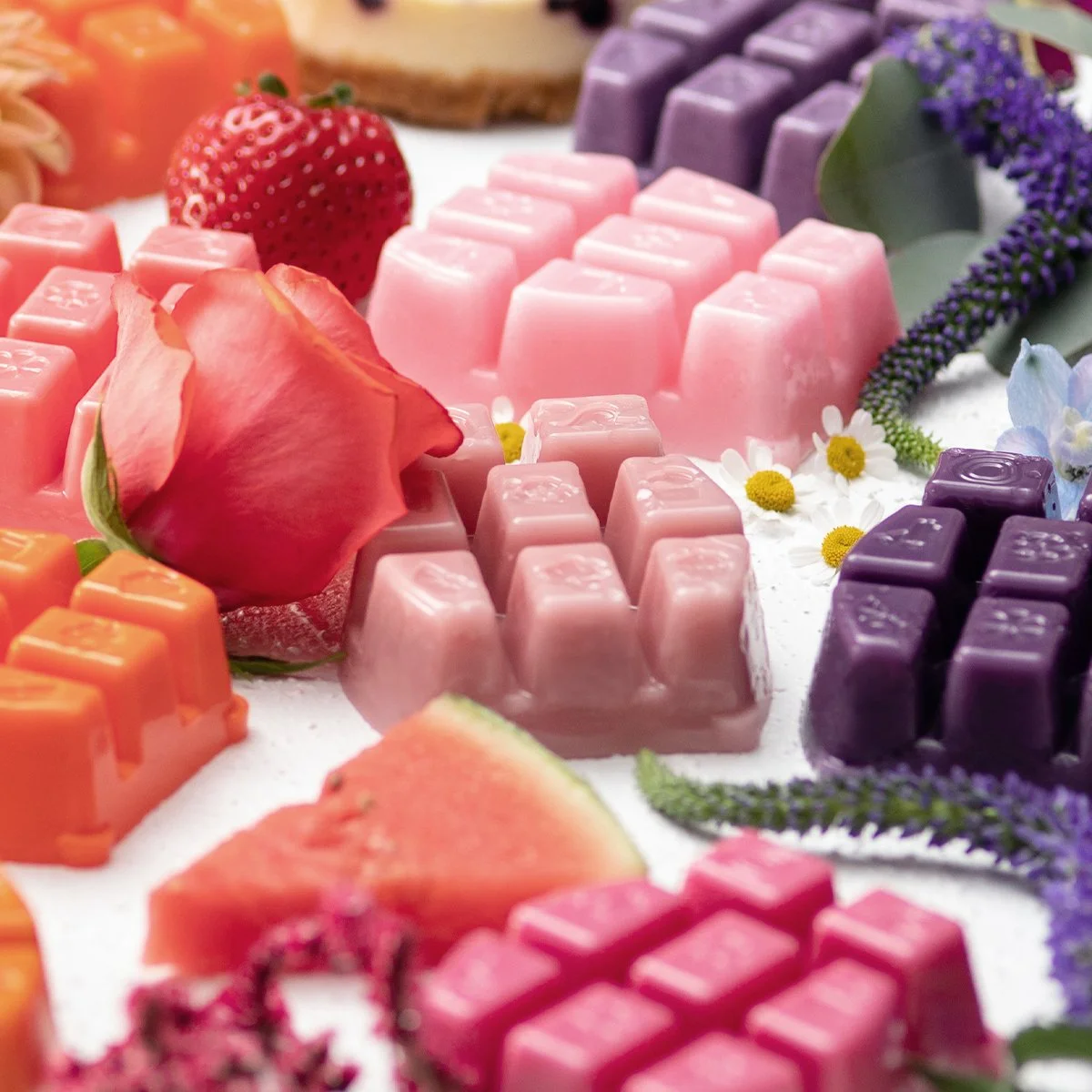 Colourful Scentsy wax bars arranged with fresh fruit and florals, representing a variety of returning fragrances for Scentsy Bring Back My Bar 2026