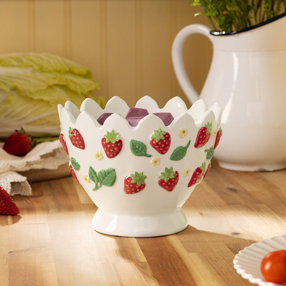 Strawberry Garden Scentsy Warmer featuring raised strawberry details, displayed with wax cubes in a bright farmhouse-style kitchen setting.
