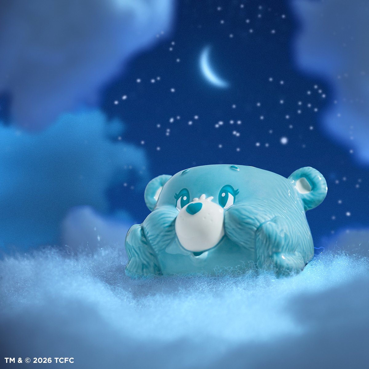 Care Bears Bedtime Bear Scentsy warmer in blue ceramic styled on soft clouds with a dreamy night sky and crescent moon background