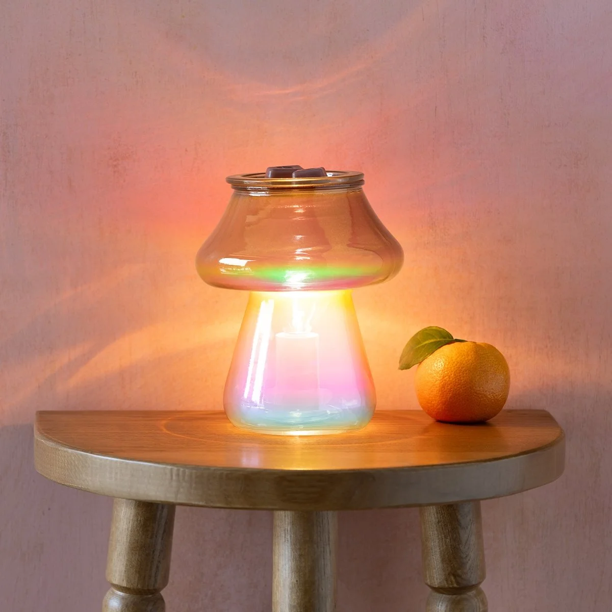 Amanita Scentsy Warmer on a tabletop glowing brightly with colourful light