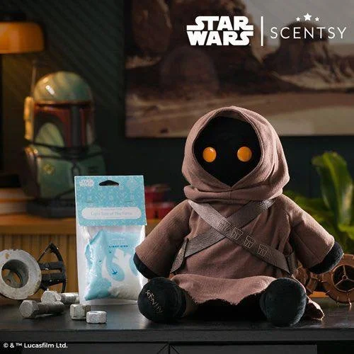 Star Wars Scentsy Jawa Buddy sitting on a table with glowing eyes beside a Scentsy scent pak in a cozy home setting