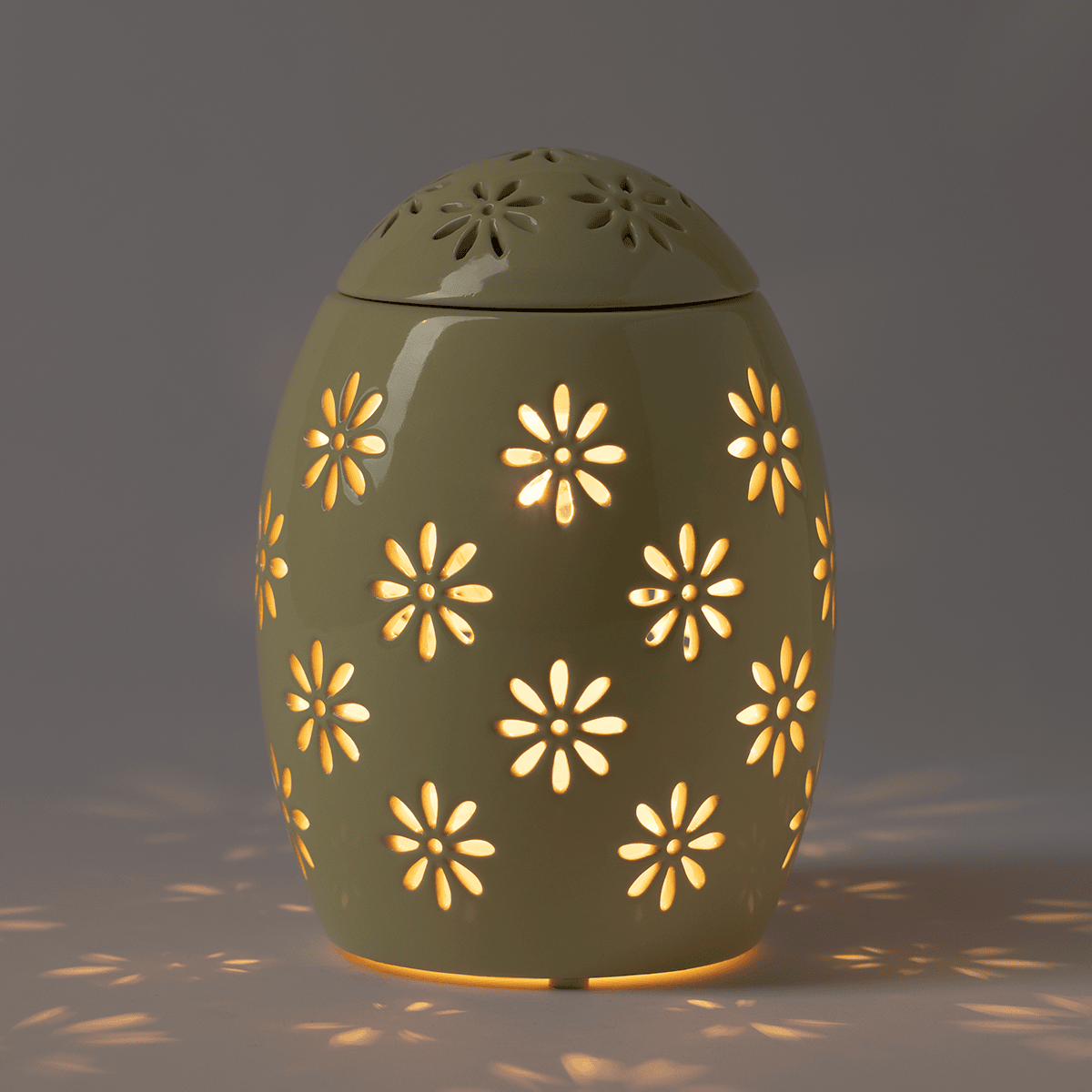 Easter Garden – Yellow Scentsy Warmer illuminated in a dim room, highlighting the floral glow pattern