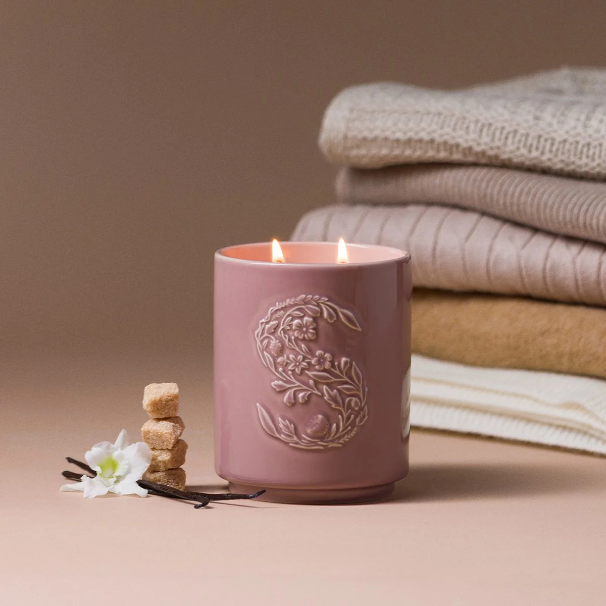 Cashmere Vanilla Sugar Scentsy Candle lit and styled with cozy blankets for a warm, relaxing setting