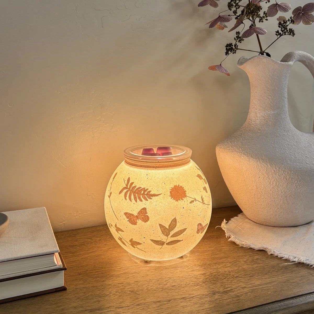 Styled in a neutral space, the Veiled Meadow Warmer adds a calming, nature-inspired accent to everyday living