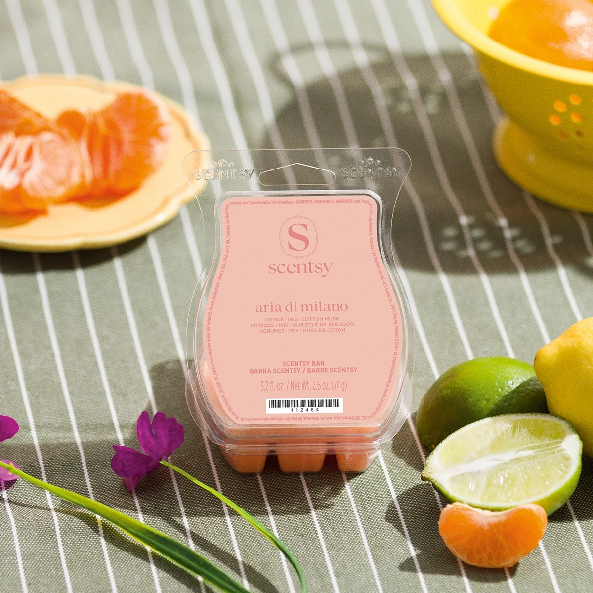 Aria di Milano Scentsy Wax Bar displayed with fresh citrus, iris blooms and linen-inspired accents, capturing the clean, elegant fragrance inspired by the streets of Milan