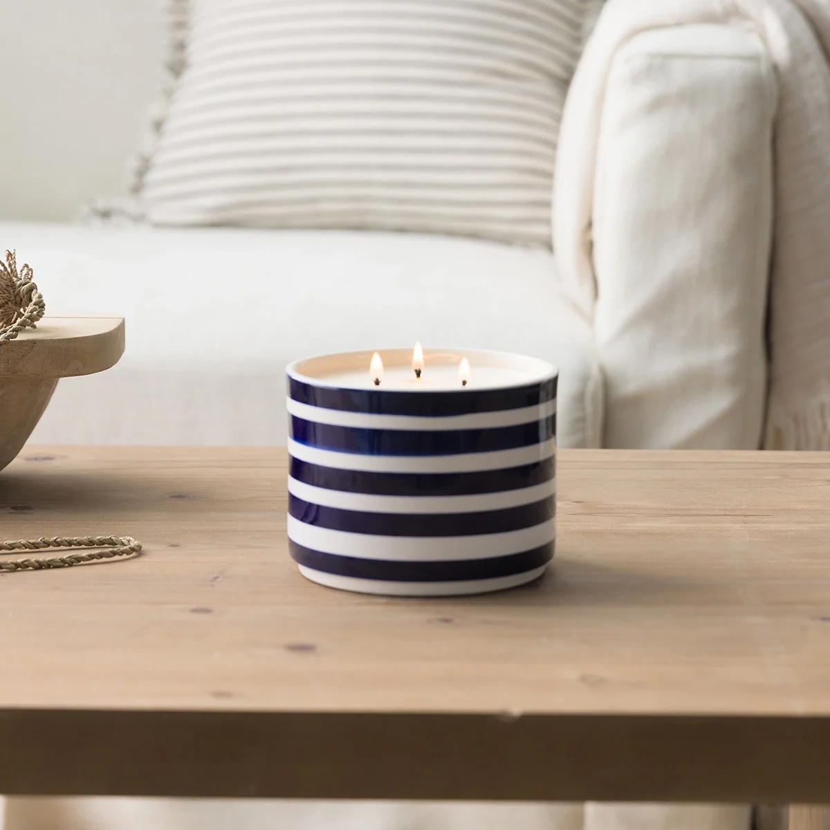 Scentsy Barefoot Beach candle on table in cozy coastal home setting