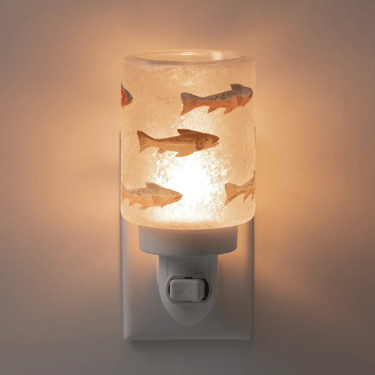 Silverfin Scentsy Mini Warmer illuminated in a dark room with a warm ambient glow