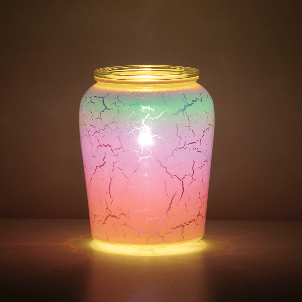 Iridescent Rainbow Scentsy Warmer glowing brightly in a dark room with colorful light