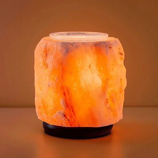 Himalayan Salt Pink Scentsy Warmer with wax in the dish glowing softly in a dark room