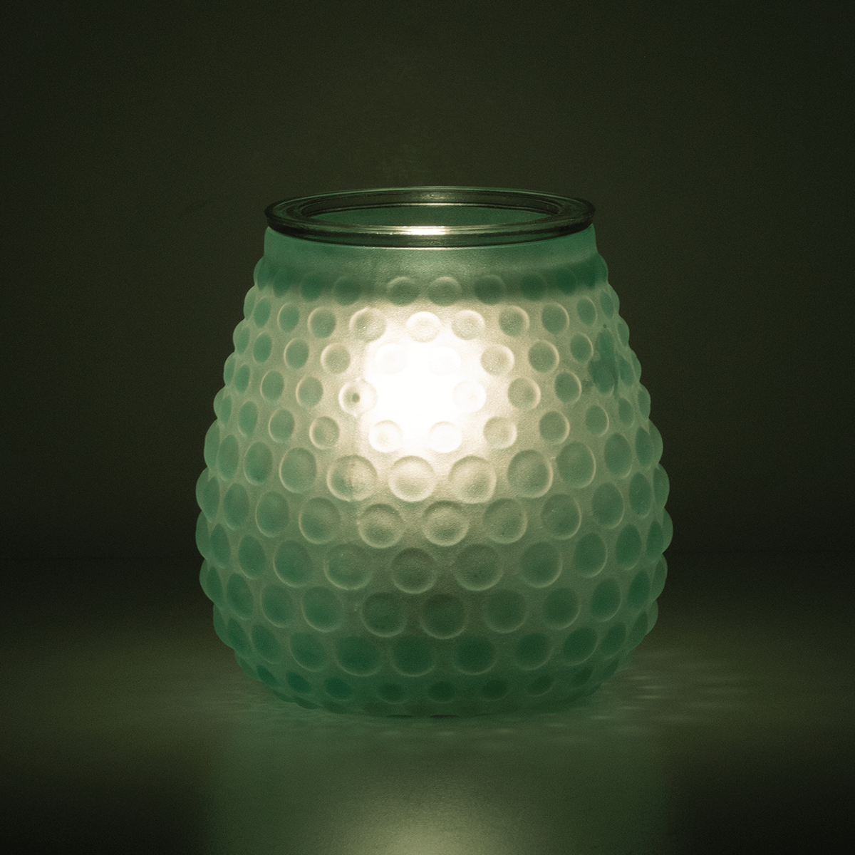 Bubble Blue Scentsy Warmer styled in a dark room glowing