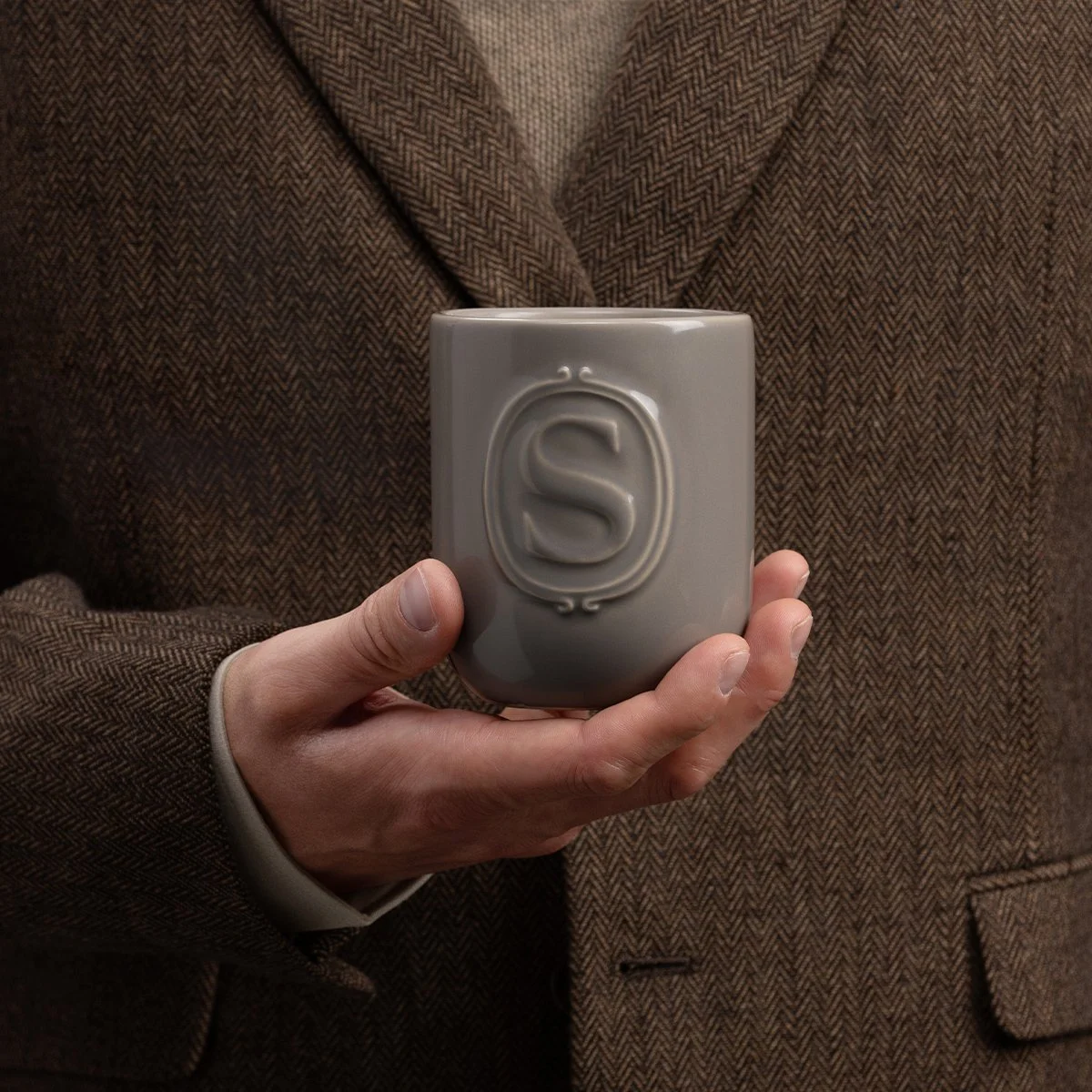 Mystery Man Scentsy Candle styled with a man holding the candle