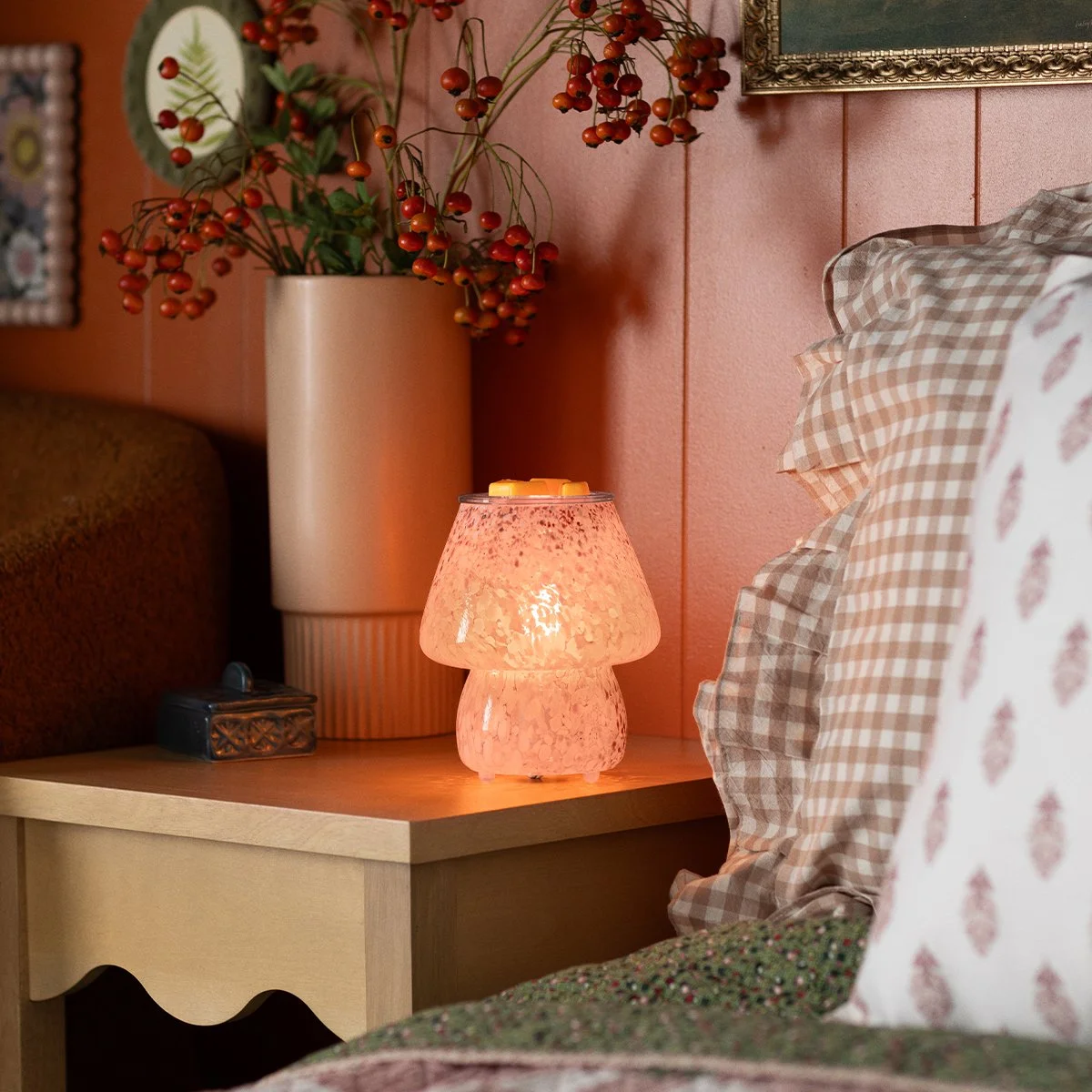 Confetti Glow Taupe Scentsy Warmer styled on a bedside table, glowing softly in a cozy home setting