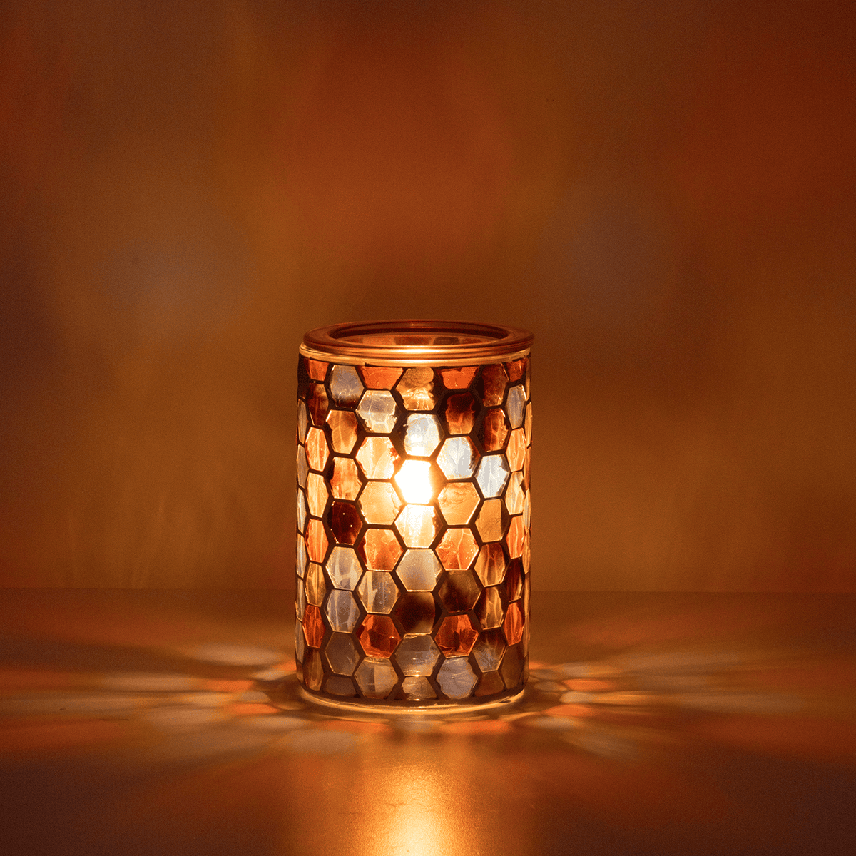 Golden Oak Scentsy Warmer glowing in a dark room with warm golden light