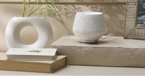 White speckled Scentsy fragrance pod diffuser displayed beside modern home décor