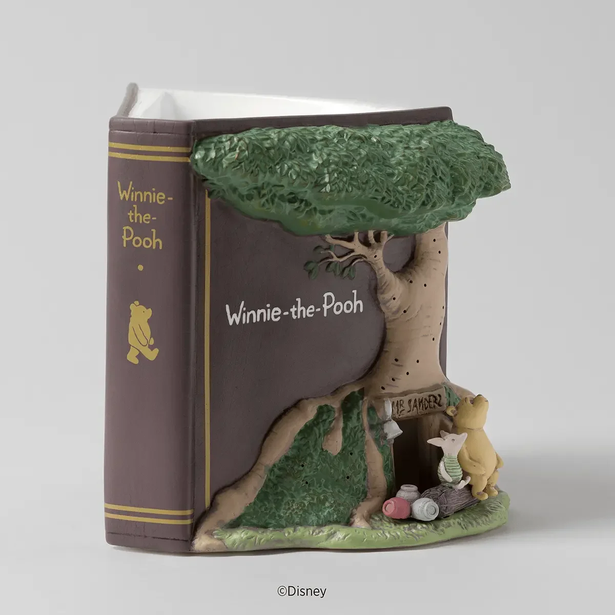 Disney Winnie the Pooh 100 Years of Friendship Scentsy Warmer featuring a storybook design with Pooh and Piglet outside Pooh's home beneath a detailed tree.