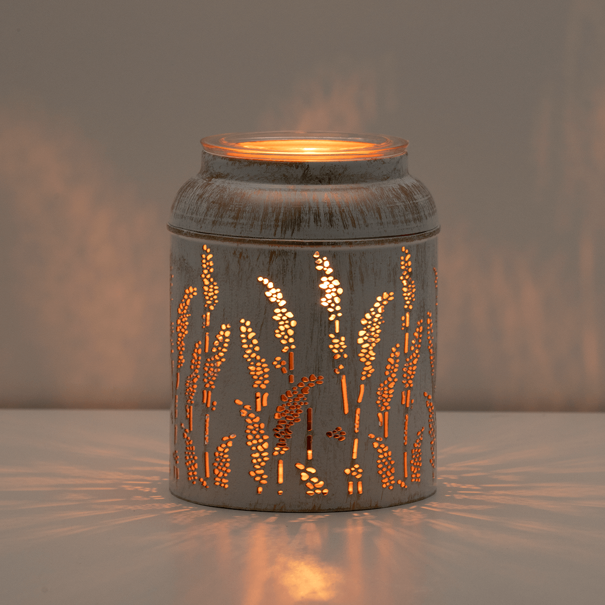 Golden Grain Scentsy Warmer glowing with warm light through metal design