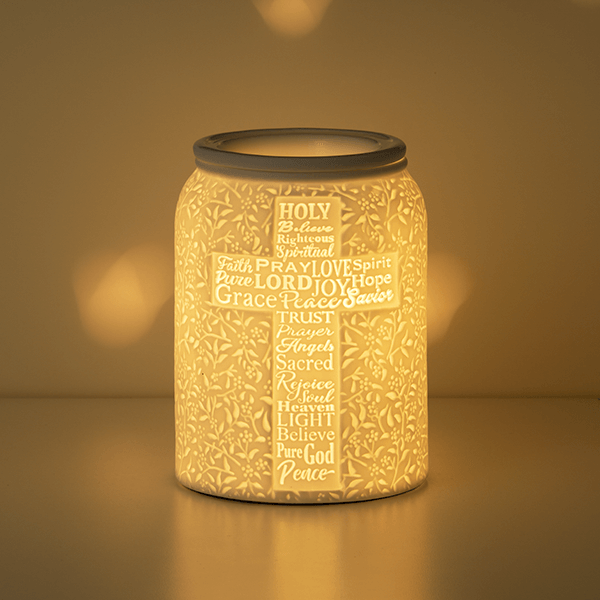 Trust in Him Scentsy Warmer with wax in the dish glowing softly styled in a dark room
