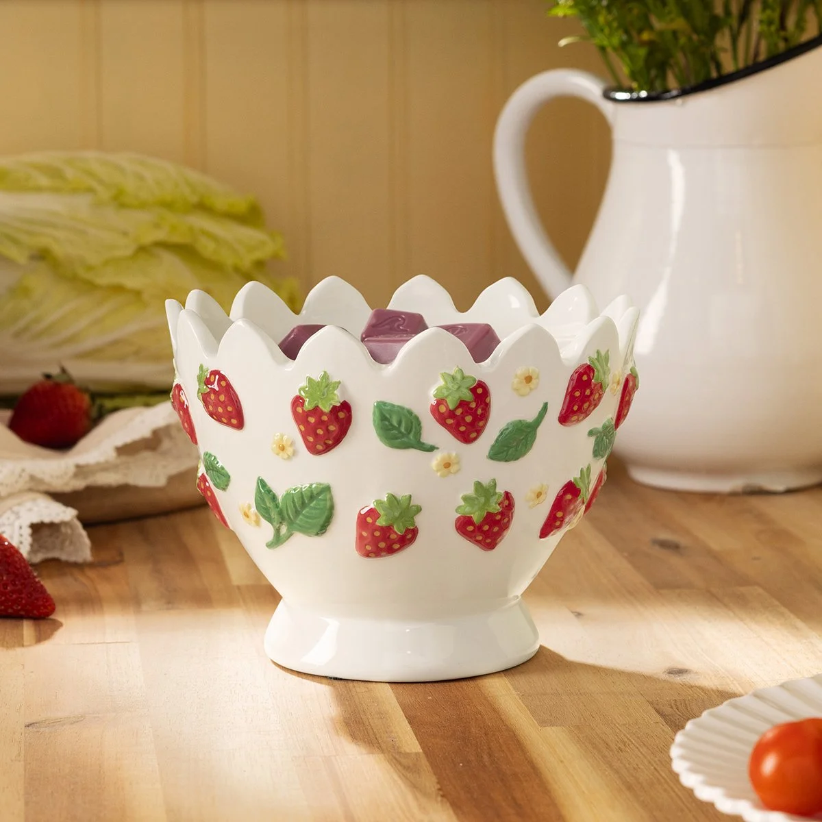 Strawberry Garden Scentsy Warmer styled on kitchen counter with wax cubes inside, surrounded by fresh strawberries and rustic decor