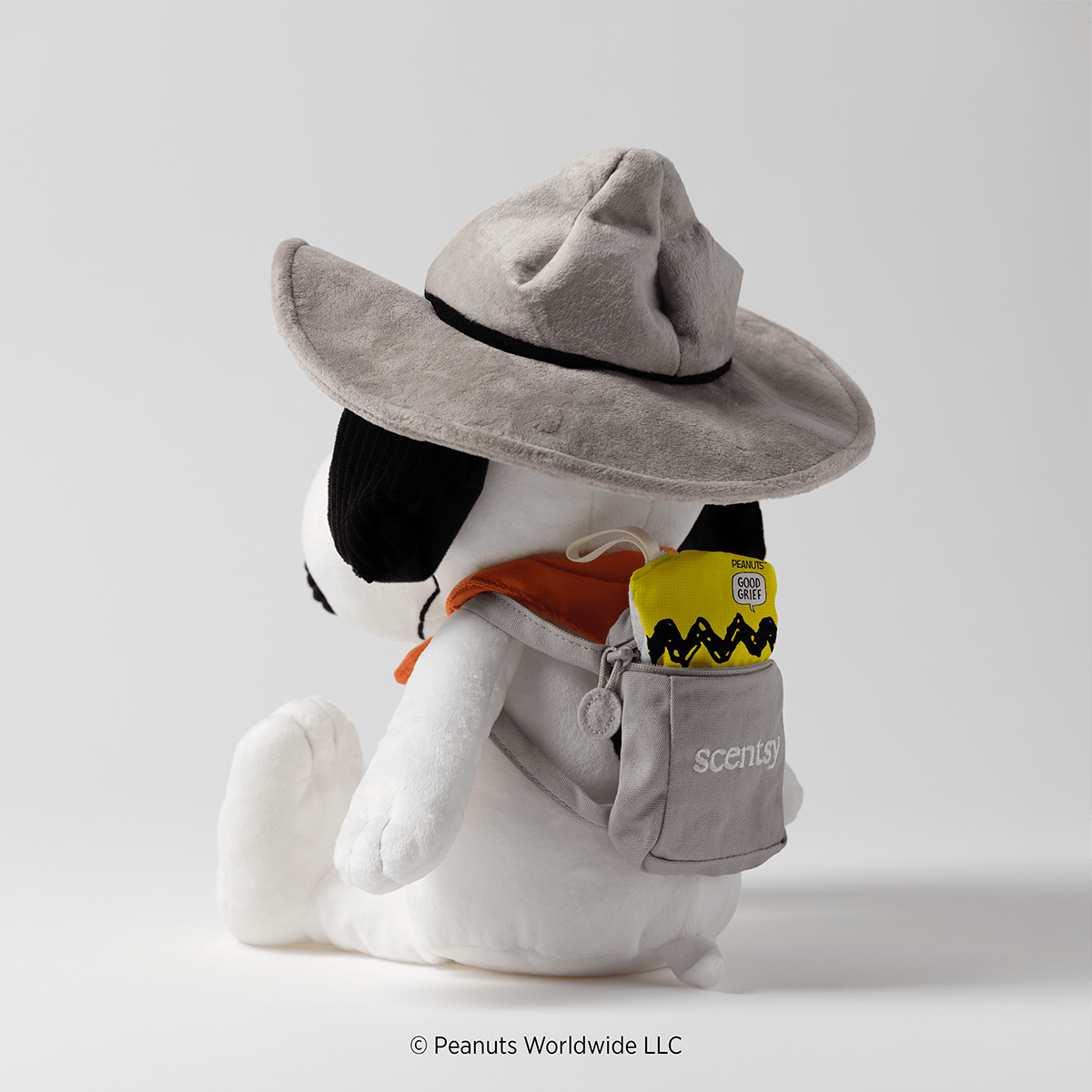 Snoopy Beagle Scouts Scentsy Buddy with a Peanuts Good Grief Scentsy Scent Pak tucked inside the attached backpack