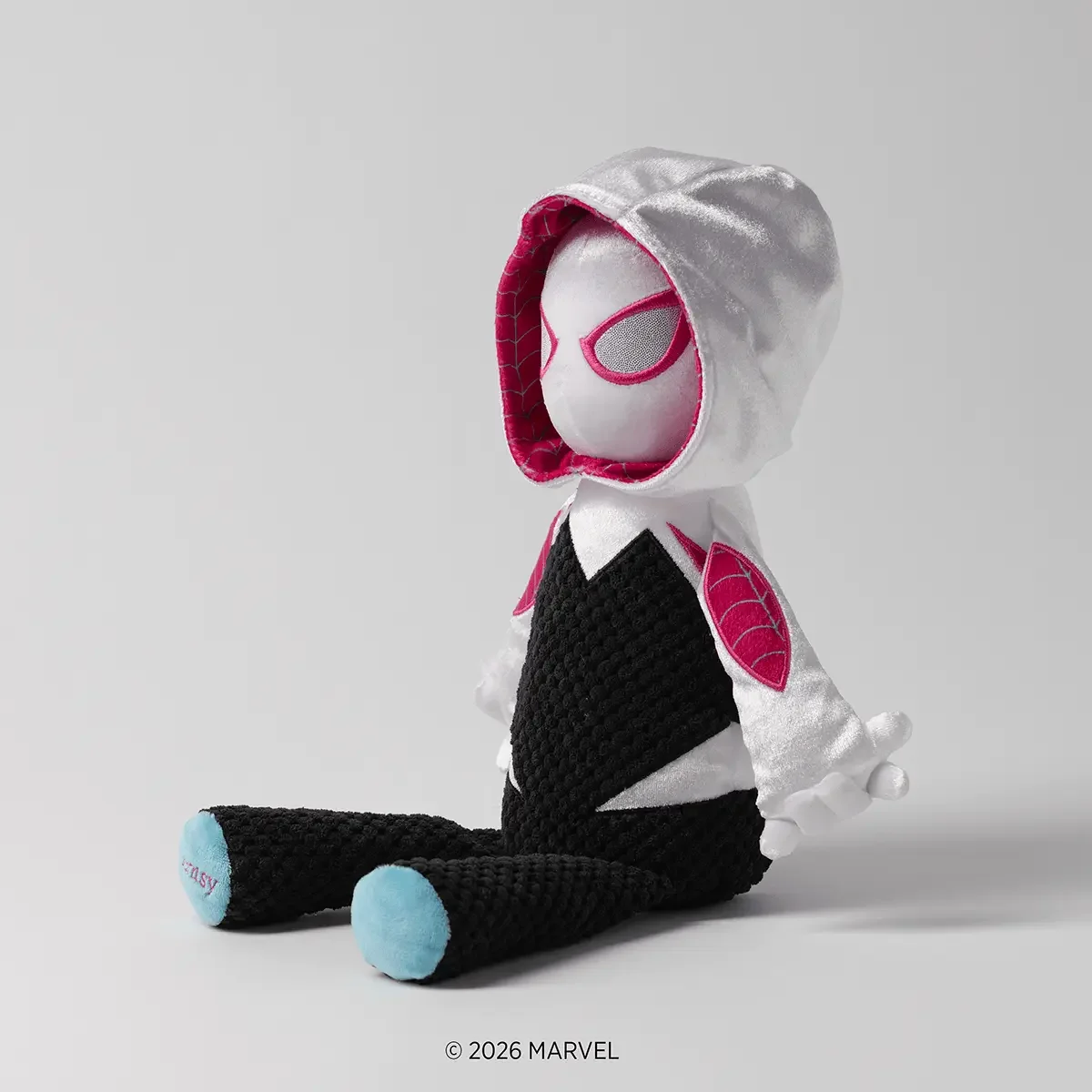 Side view of Marvel Ghost-Spider Scentsy Buddy featuring her white hood and black, white and pink design