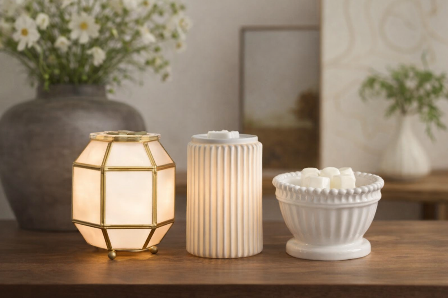 scentsy ninspire collection three warmers on a table styled glowing