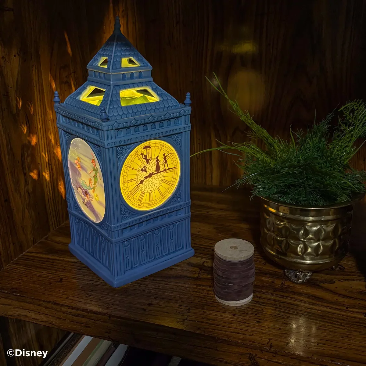 ey Peter Pan Flight to Never Land Scentsy warmer glowing with detailed clock design and storybook artwork
