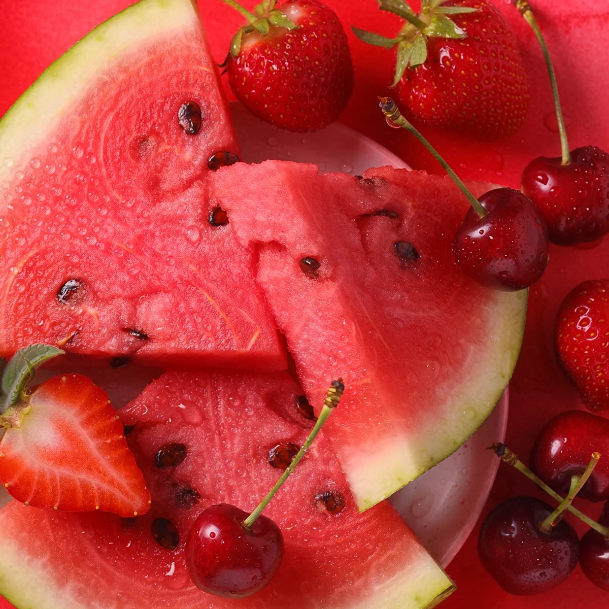 Rainbow Red Scentsy fragrance inspiration with watermelon slices, strawberries and cherries on a bright red background