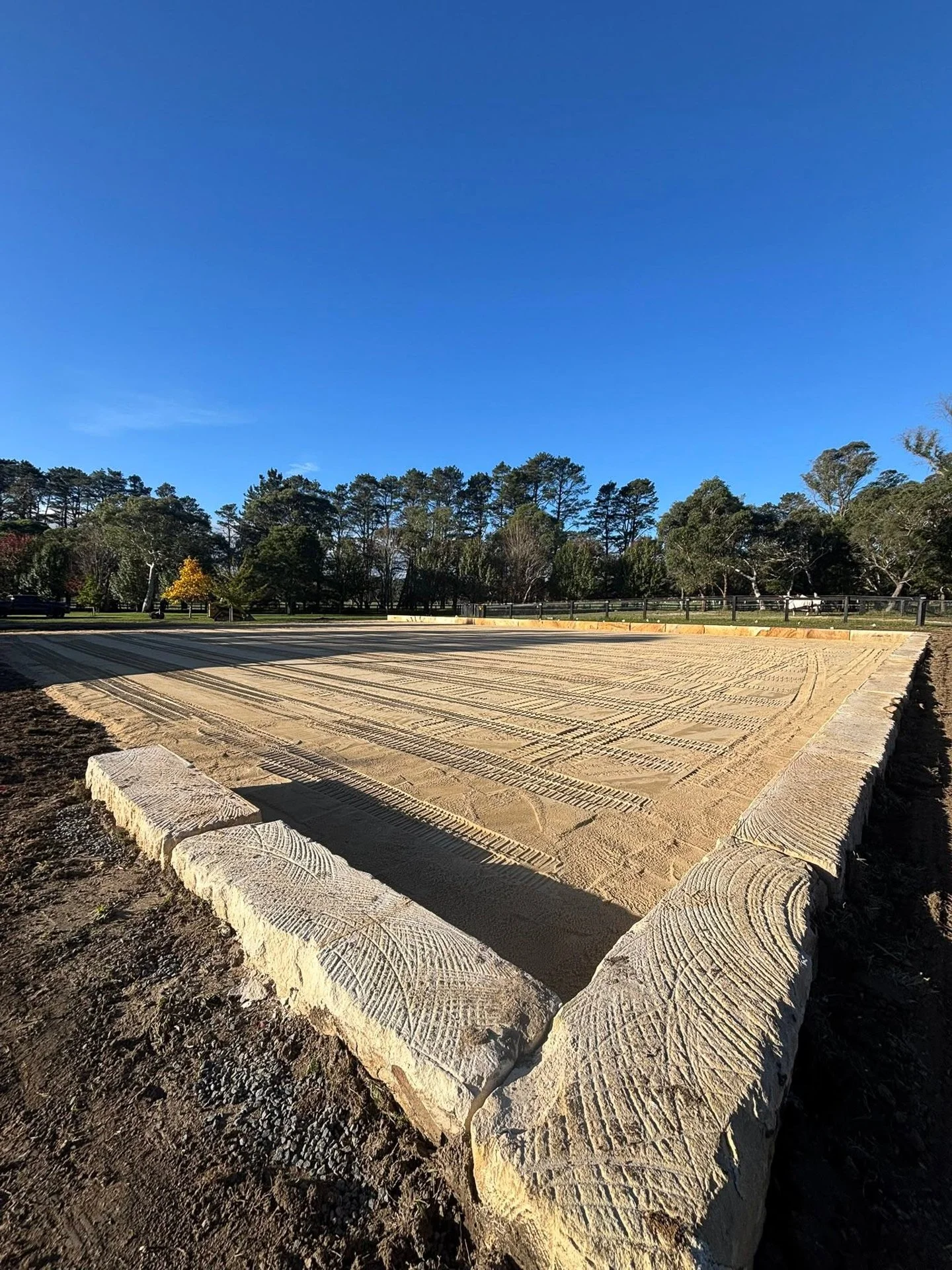Horse arena construction with sandstone retaining blocks