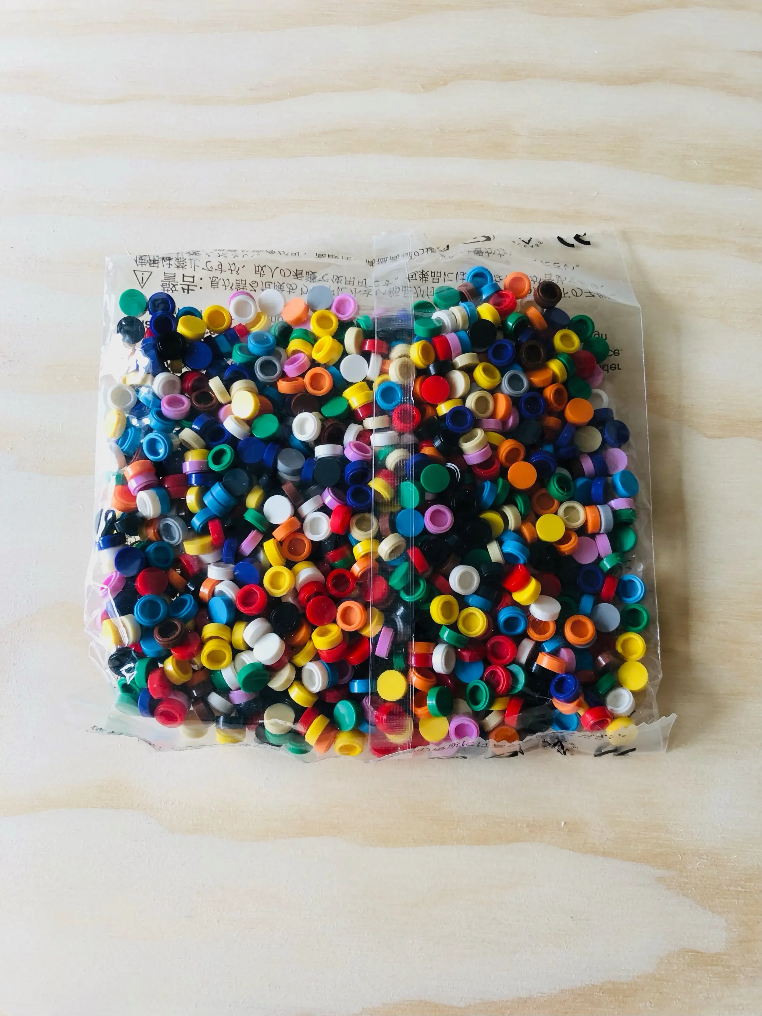 A clear refill bag of colorful 1x1 building block dots for the Jaim lamp. An expansion pack of pixel art tiles for endless creative design possibilities.