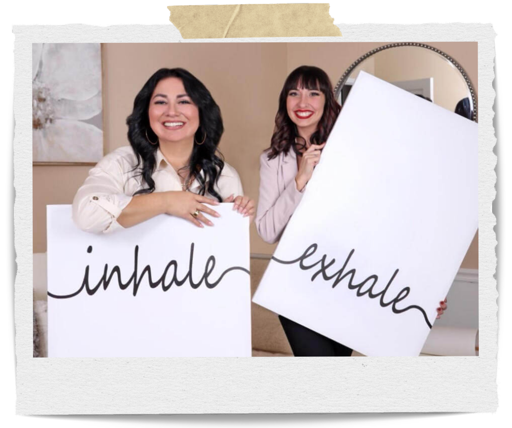 Pilar and Rebecca holding inhale and exhale signs at Nova Counseling Services