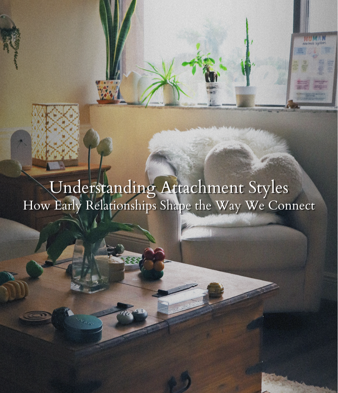A warm, softly lit therapy office with a cozy chair, heart-shaped pillow, plants, and calming decor, representing emotional safety, connection, and healing in relationships.