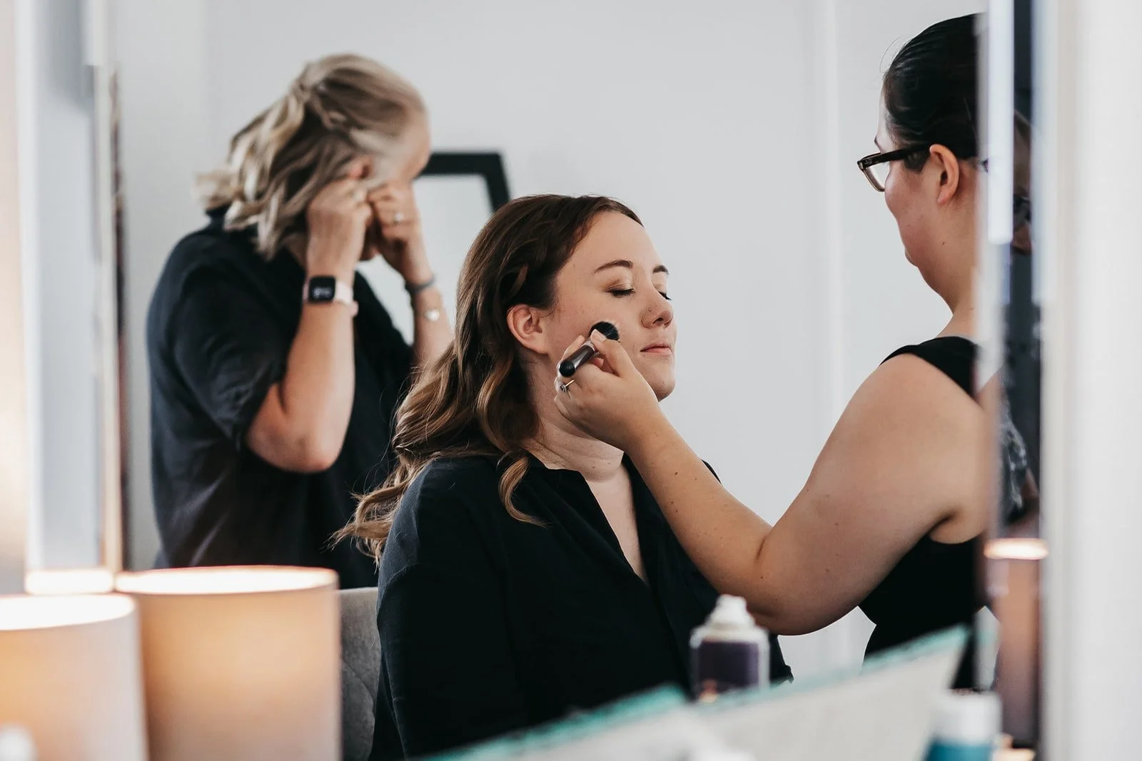 A bride having her makeup done, in a natural style ready for her wedding day at Villiers Barn in Essex.